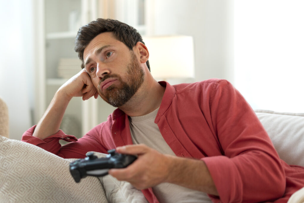 Sad person playing game with controller